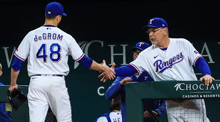 Rangers’ Jacob deGrom shakes manager Bruce Bochy’s hand after being taken out of a game.